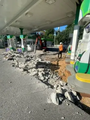 Broken concrete removed from the dispenser-side work area.