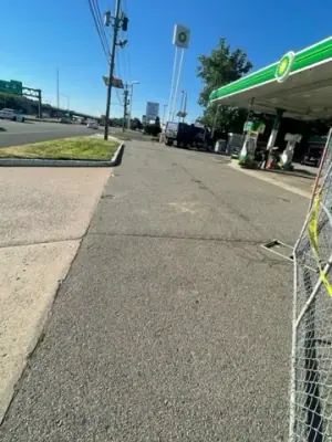 Existing paved access lane beside the station canopy.
