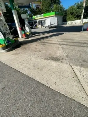 Concrete forecourt surface extending toward the station building.