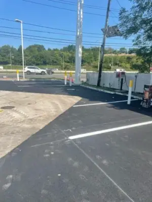 White parking-space lines on the resurfaced forecourt.