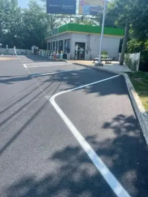 Freshly marked parking and access lanes in front of the shop.