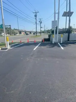 White parking lines near the roadside station sign.