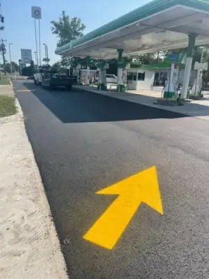 Yellow traffic-direction arrow leading toward the dispenser lanes.