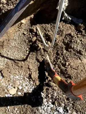 Exposed pipe connections at the bottom of the excavation.