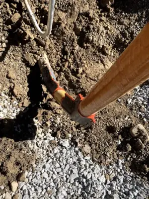 Exposed pipe connections at the bottom of the excavation.