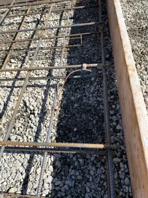 Reinforcing steel and timber forms prepared for the tank foundation.