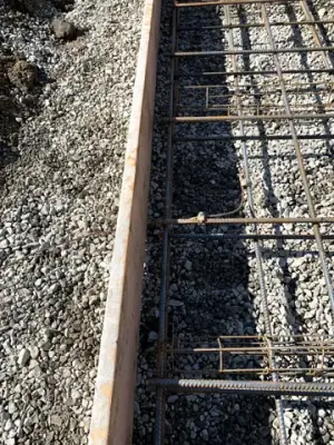 Reinforcing steel and timber forms prepared for the tank foundation.
