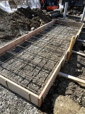 Reinforcing steel and timber forms prepared for the tank foundation.