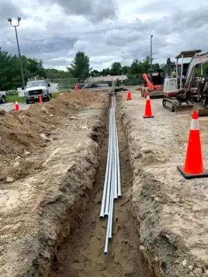Open utility trench and conduit runs connecting the facility to the fueling area.