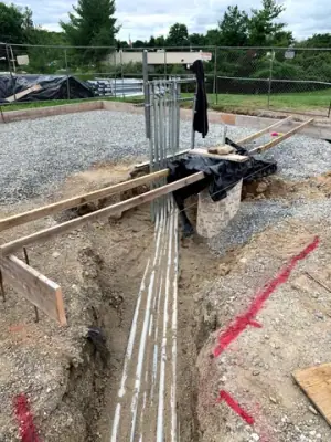 Open utility trench and conduit runs connecting the facility to the fueling area.