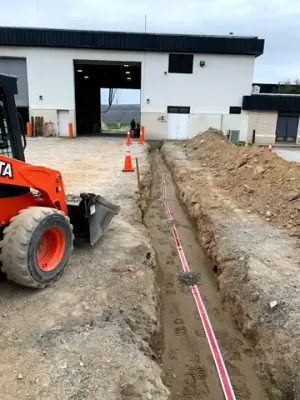 Open utility trench and conduit runs connecting the facility to the fueling area.