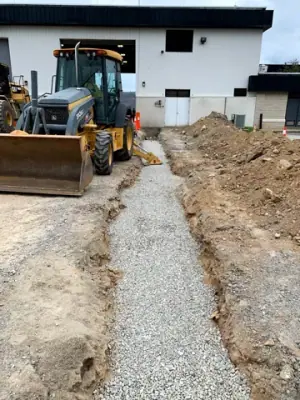 Open utility trench and conduit runs connecting the facility to the fueling area.