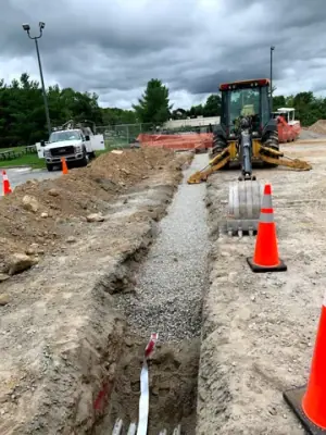 Open utility trench and conduit runs connecting the facility to the fueling area.