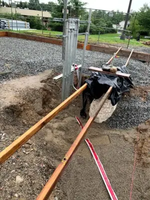Open utility trench and conduit runs connecting the facility to the fueling area.