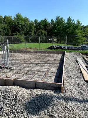 Reinforcing steel in the prepared concrete foundation forms.