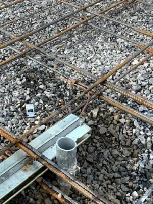 Reinforcement and pipe penetrations within the foundation formwork.