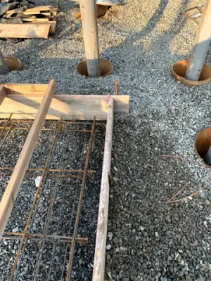 Reinforcement and pipe penetrations within the foundation formwork.