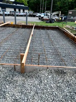 Reinforcing steel and timber forms across the prepared foundation.