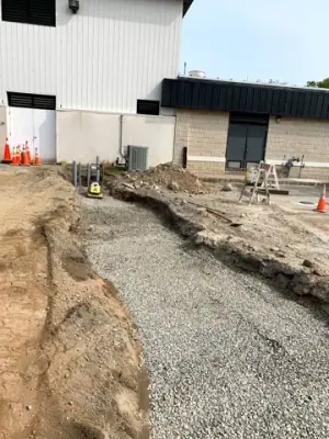 Backfilled utility route between the building and fueling area.