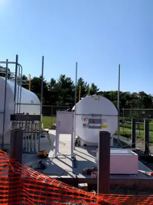 Aboveground tanks and dispensing equipment positioned on the concrete foundation.