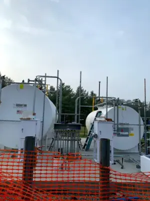 Aboveground tanks and dispensing equipment positioned on the concrete foundation.