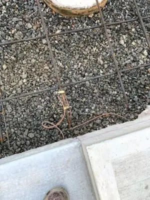 Aggregate and concrete joint at the edge of the fueling apron.
