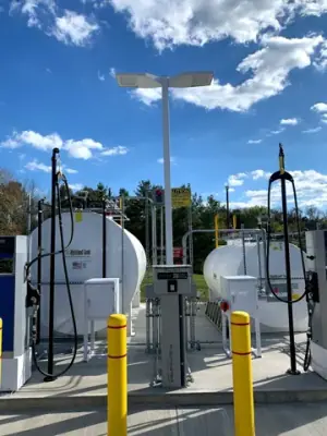 Fueling equipment and overhead hose supports beside the tank.