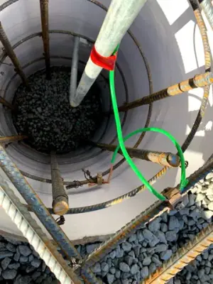 Connections and conduits inside an open containment chamber.