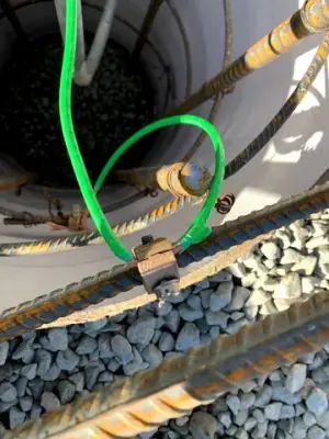 Connections and conduits inside an open containment chamber.