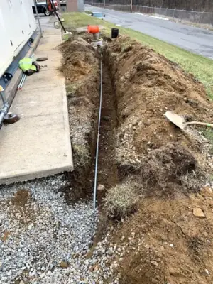 Trench and marked underground services beside the facility.