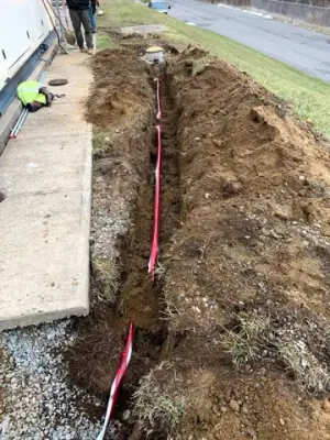 Trench and marked underground services beside the facility.