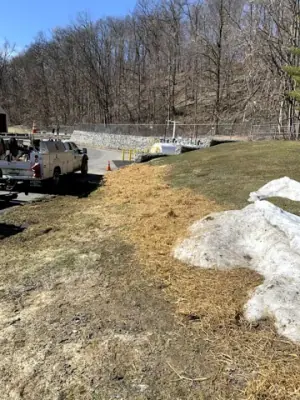 Restored grassed slope along the utility route to the facility building.