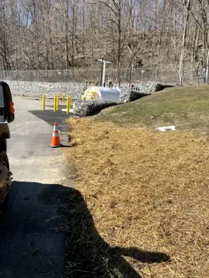 Restored grassed slope along the utility route to the facility building.