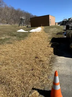 Restored grassed slope along the utility route to the facility building.
