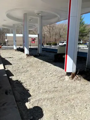 Excavated aggregate surface beneath the Lukoil canopy.