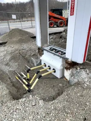 Exposed equipment-base connections beside a canopy column.