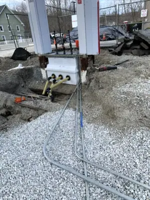 Conduit bends routed from the main trench toward the equipment bases.