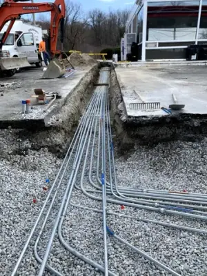 Conduit bends routed from the main trench toward the equipment bases.