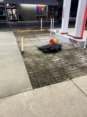 A worker prepares reinforcing mesh in a formed concrete bay.