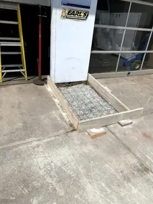 Small formed aggregate pad at a building entrance.