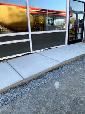 Finished concrete sidewalk around the storefront.