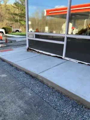 Finished concrete sidewalk around the storefront.