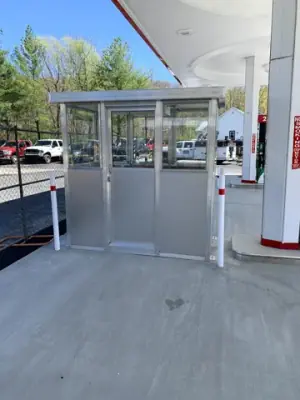 Attendant booth and canopy column on the concrete forecourt.
