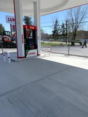 Fuel dispenser and protective rails on the finished concrete surface.