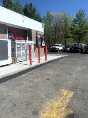 Finished storefront walkway and red protective posts.