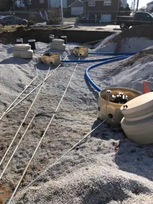 Underground services routed across the prepared tank area.