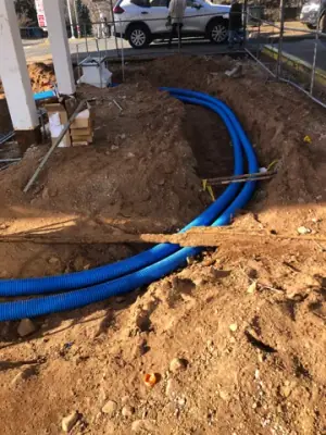 Curved blue piping and metal conduits at the fueling island.
