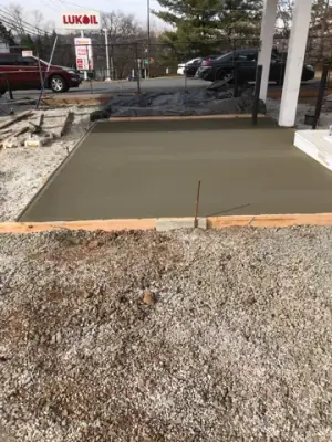 Fresh concrete placed in a formed fueling-island bay.