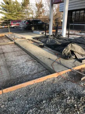 Reinforcing mesh and timber forms prepared for the fueling-lane concrete.