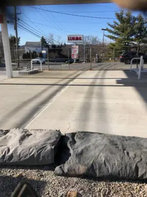 Finished concrete forecourt viewed toward the attendant booth.